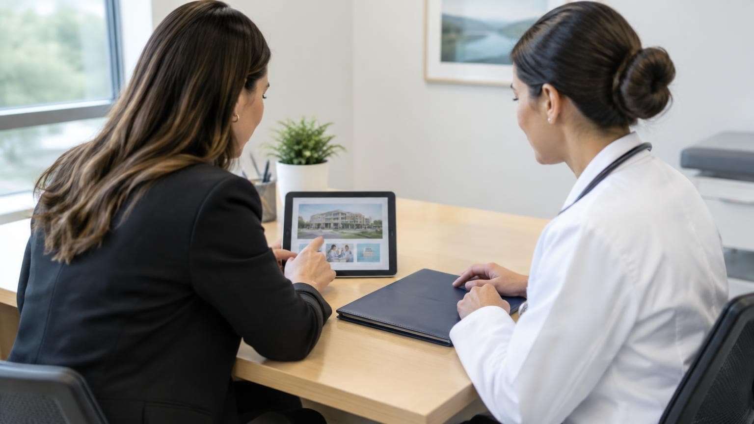 A clinician and coordinator reviewing healthcare website materials.