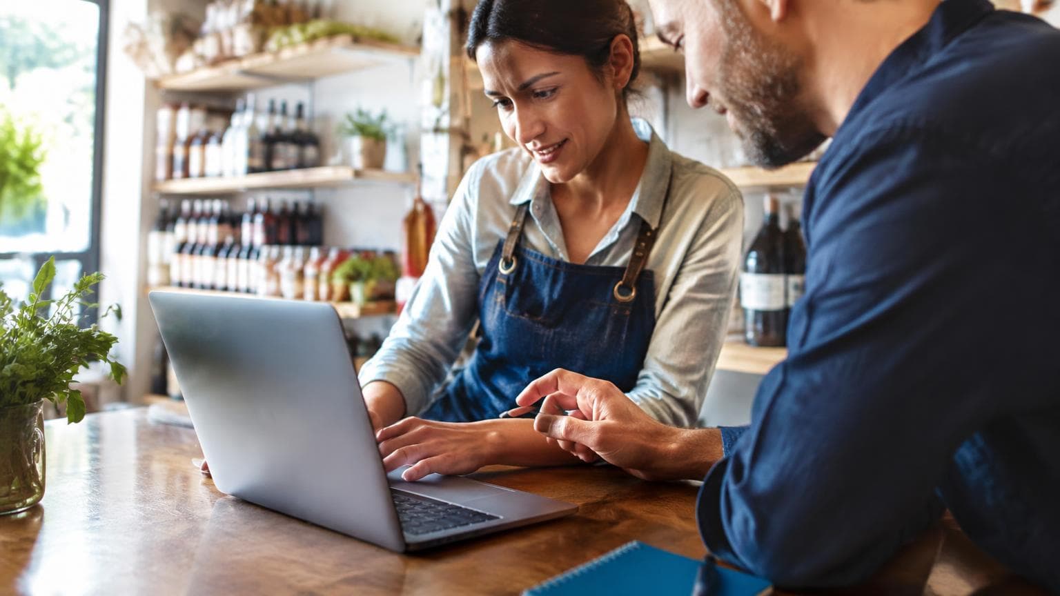 A small business owner working with a marketing collaborator.